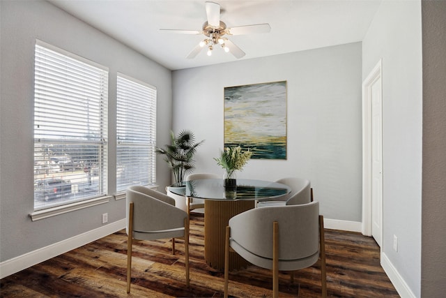 dining area featuring a ceiling fan, baseboards, and wood finished floors