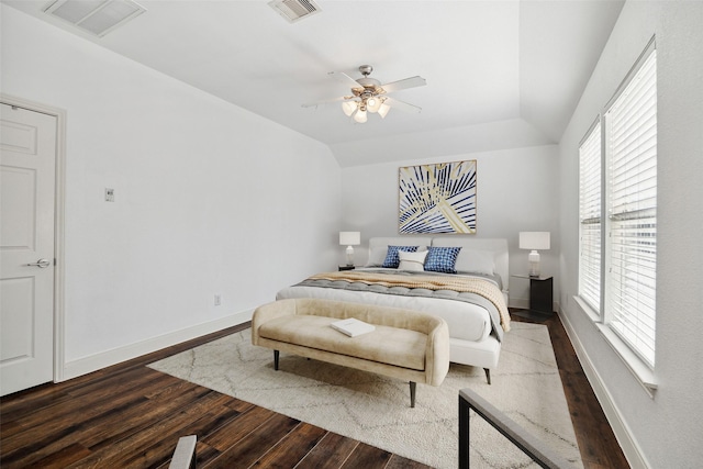 bedroom featuring visible vents, baseboards, and wood finished floors