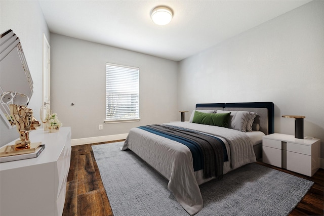 bedroom featuring dark wood-type flooring and baseboards