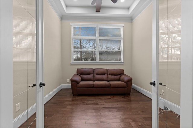 sitting room featuring a healthy amount of sunlight, baseboards, and wood finished floors