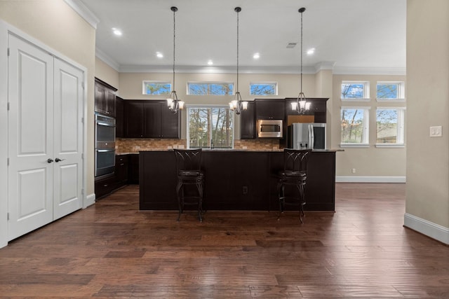 kitchen featuring dark wood-style floors, tasteful backsplash, a chandelier, and stainless steel appliances