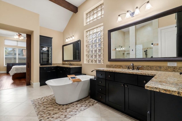 full bathroom with a stall shower, baseboards, lofted ceiling with beams, tile patterned flooring, and a freestanding tub