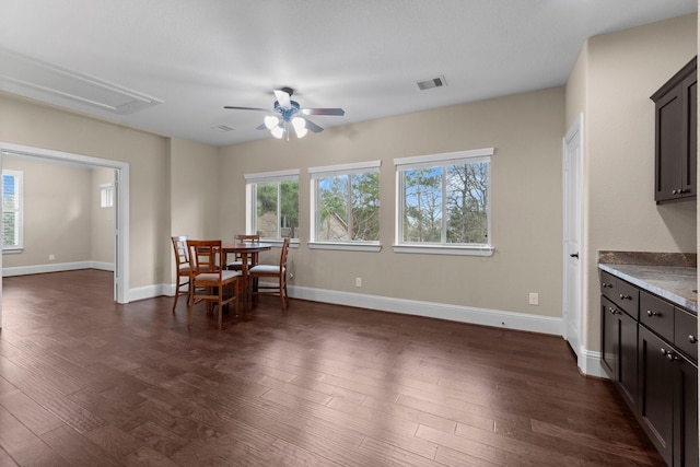 dining area featuring attic access, baseboards, visible vents, dark wood finished floors, and ceiling fan