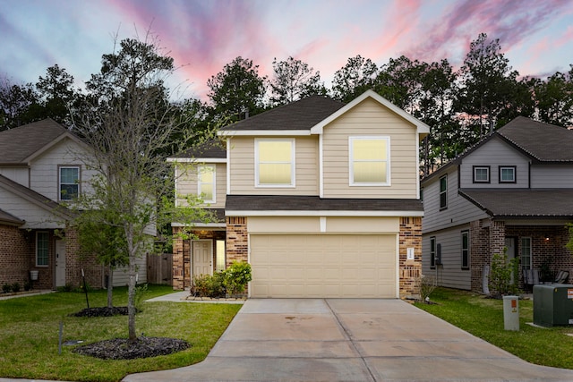 traditional-style home with an attached garage, brick siding, driveway, roof with shingles, and a front lawn