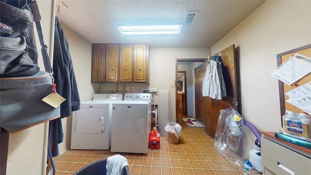 washroom featuring light tile patterned floors, cabinet space, visible vents, a textured ceiling, and independent washer and dryer