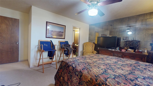 carpeted bedroom featuring ceiling fan, baseboards, and tile walls