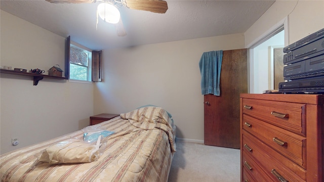 bedroom featuring light carpet and ceiling fan