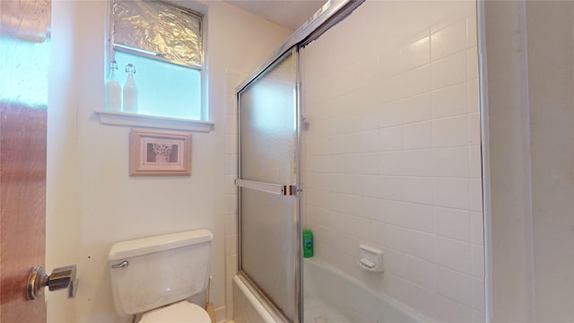 bathroom featuring toilet and enclosed tub / shower combo