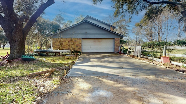 view of side of home featuring an outbuilding, brick siding, and fence