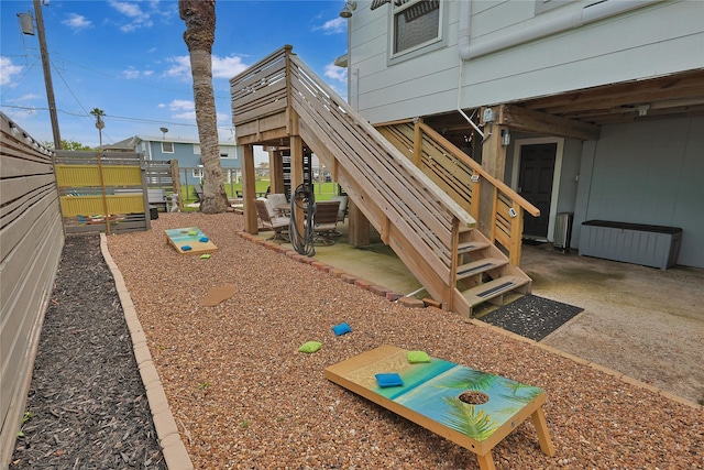 view of playground featuring stairs and fence