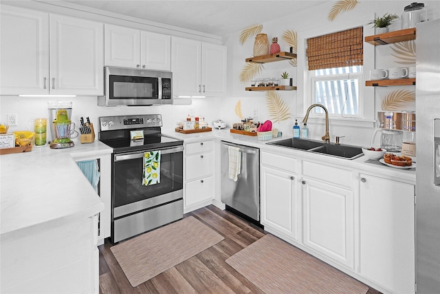 16615 Jamaica Inn Rd, Galveston, TX 77554 - kitchen with white cabinets, open shelves, appliances with stainless steel finishes, and a sink