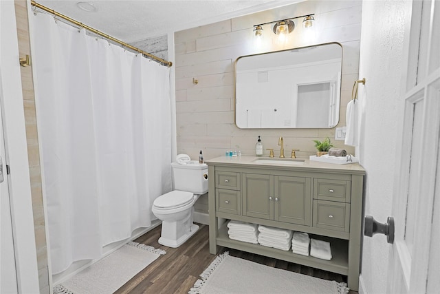 full bathroom featuring vanity, curtained shower, wood finished floors, and toilet