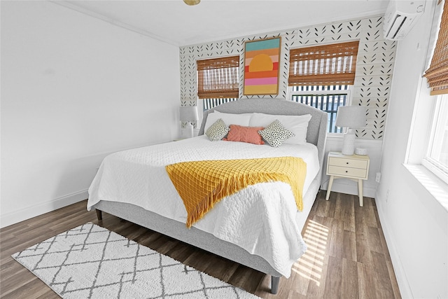 16615 Jamaica Inn Rd, Galveston, TX 77554 - bedroom featuring baseboards, ornamental molding, wood finished floors, and a wall mounted air conditioner