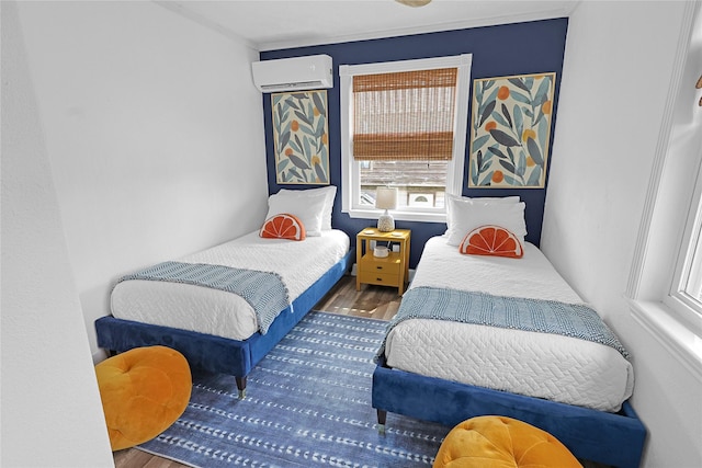 bedroom featuring an AC wall unit and wood finished floors