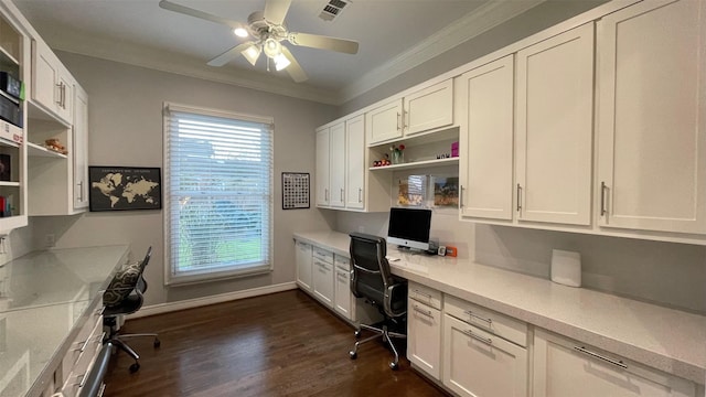 office area with baseboards, visible vents, dark wood finished floors, ornamental molding, and built in desk