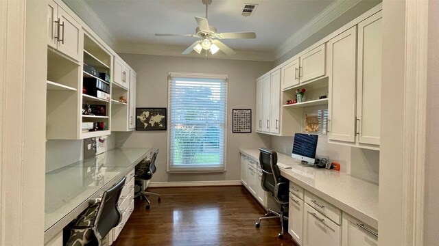 office with dark wood-style floors, crown molding, visible vents, and built in desk