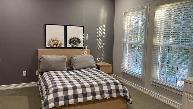 bedroom featuring carpet flooring and baseboards