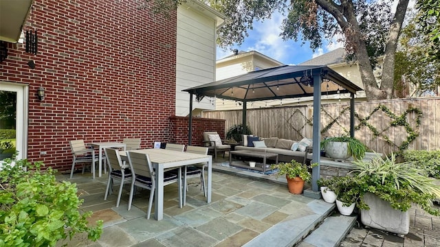 view of patio with an outdoor hangout area, a gazebo, outdoor dining area, and fence