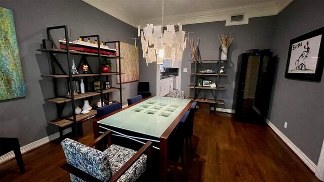 office featuring visible vents, crown molding, baseboards, and wood finished floors