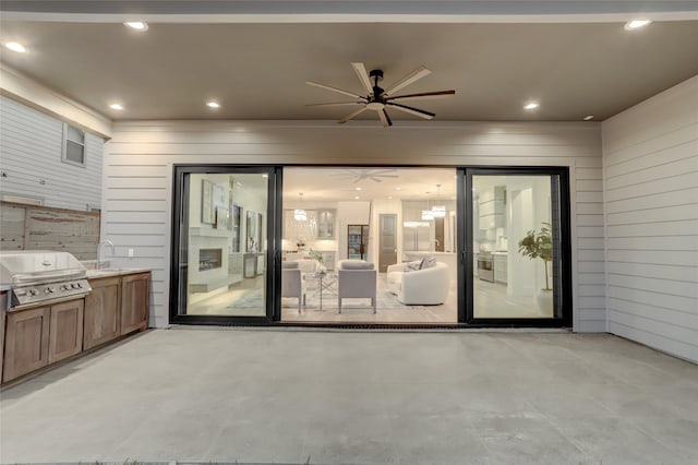 view of patio with a grill, ceiling fan, and a sink