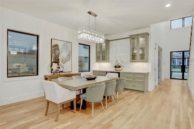 dining area featuring a healthy amount of sunlight, light wood finished floors, baseboards, and recessed lighting