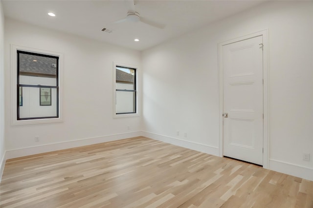 spare room featuring light wood-type flooring, ceiling fan, baseboards, and recessed lighting