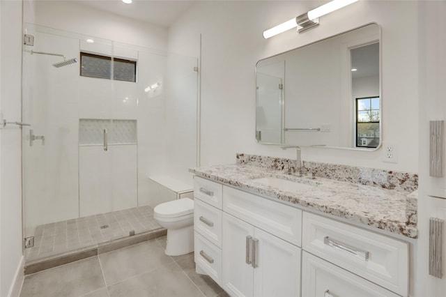 full bathroom with a stall shower, vanity, toilet, and tile patterned floors