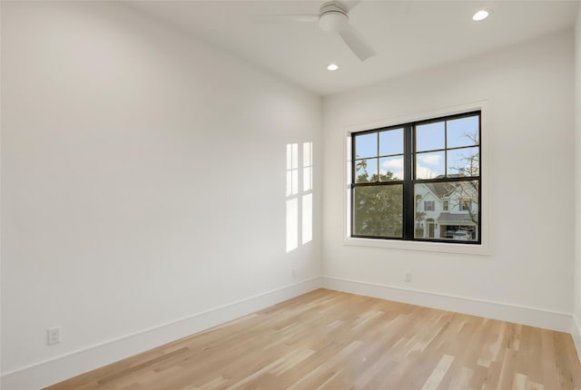 empty room with ceiling fan, light wood finished floors, recessed lighting, and baseboards