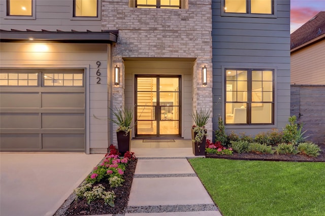 exterior entry at dusk with a garage