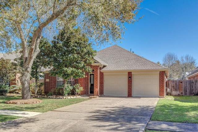 view of front of property with brick siding, a front yard, fence, a garage, and driveway