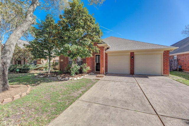 view of front of house with a garage, driveway, a front lawn, and brick siding