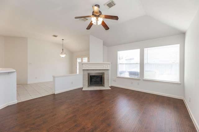 unfurnished living room with vaulted ceiling, visible vents, and a healthy amount of sunlight