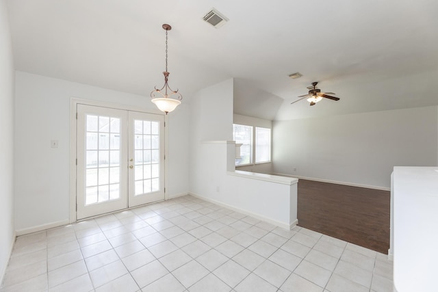 spare room featuring french doors, visible vents, baseboards, and light tile patterned floors