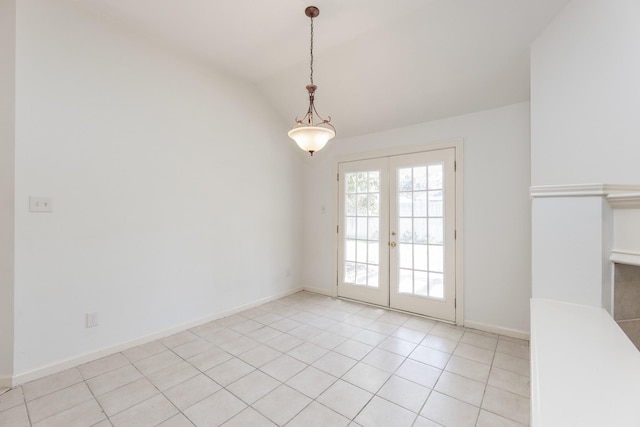 interior space with lofted ceiling, french doors, light tile patterned flooring, and baseboards