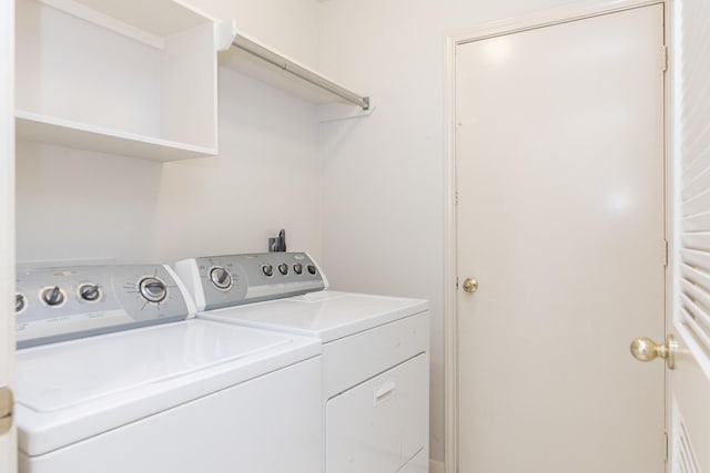 clothes washing area featuring laundry area and washer and clothes dryer