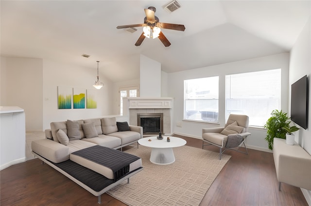 living area with a wealth of natural light, visible vents, and vaulted ceiling