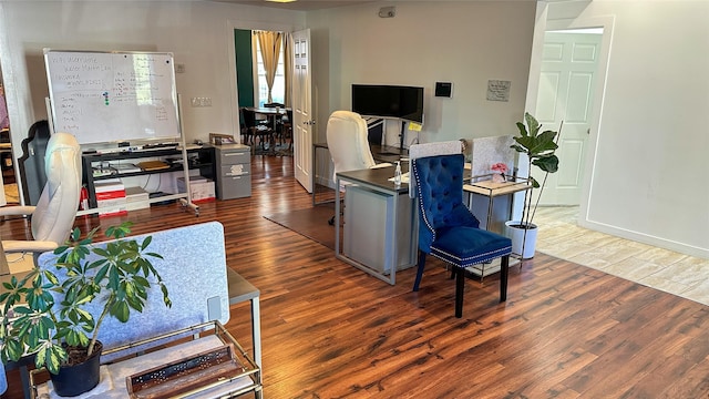 living area with wood finished floors and baseboards