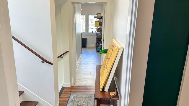 corridor featuring stairway and wood finished floors