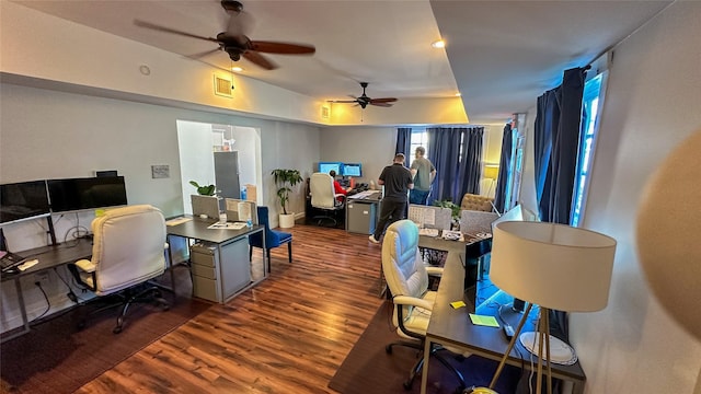 office area with a ceiling fan, visible vents, and wood finished floors