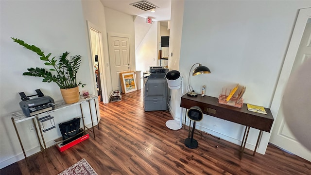 interior space featuring baseboards, visible vents, and wood finished floors