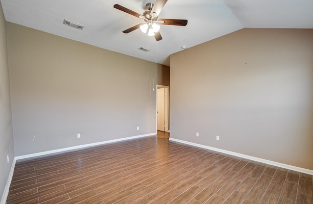 empty room featuring a ceiling fan, visible vents, and wood finished floors