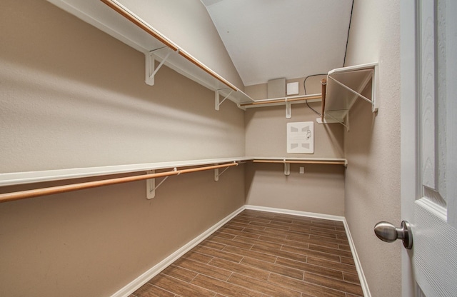 spacious closet featuring vaulted ceiling and wood tiled floor