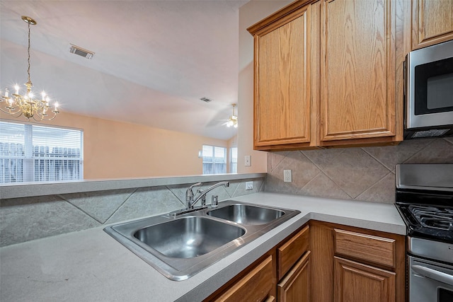 kitchen featuring tasteful backsplash, visible vents, appliances with stainless steel finishes, and a sink