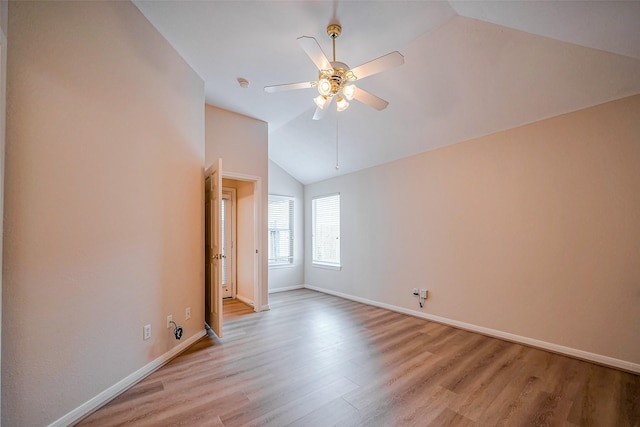 interior space with light wood-style flooring, baseboards, lofted ceiling, and ceiling fan