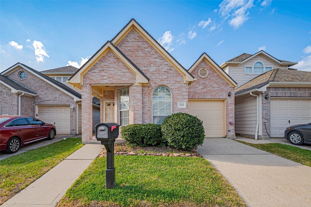 view of front of property featuring a front lawn, brick siding, and driveway