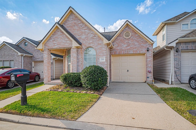 view of front of property featuring brick siding, an attached garage, and driveway