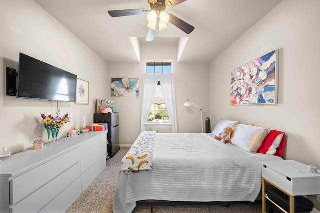 carpeted bedroom featuring freestanding refrigerator and a ceiling fan