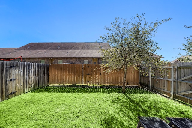 view of yard with a fenced backyard