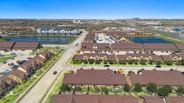 birds eye view of property featuring a water view and a residential view