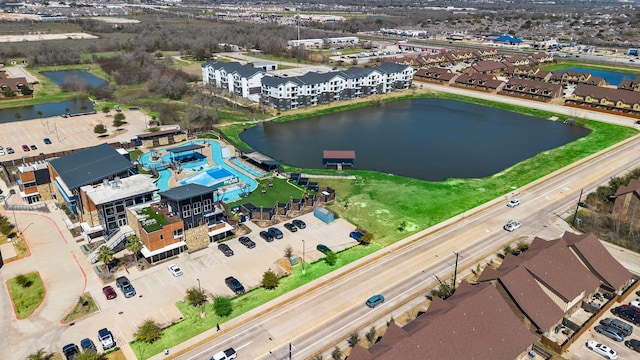 birds eye view of property with a water view and a residential view